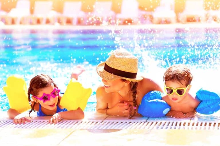 Happy family enjoying swimming pool