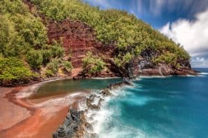 Spectacular Red Sand Beach in the town of Hana on the tropical Island of Maui Hawaii