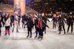 Ice skaters enjoy the falling snow at the Bryant Park skating rink in Manhattan