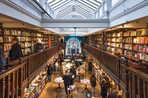 Daunt Books interior showcasing wooden shelves skylight and customers browsing books Marylebone uk
