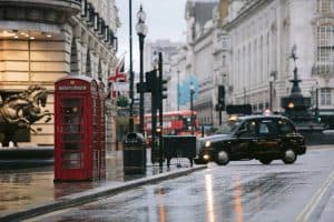 London street on a rainy day with red telephone boot and taxi sp