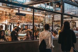 Women walking past the windows of Buns and Buns restaurant london