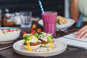 person eating breakfast with menu sp